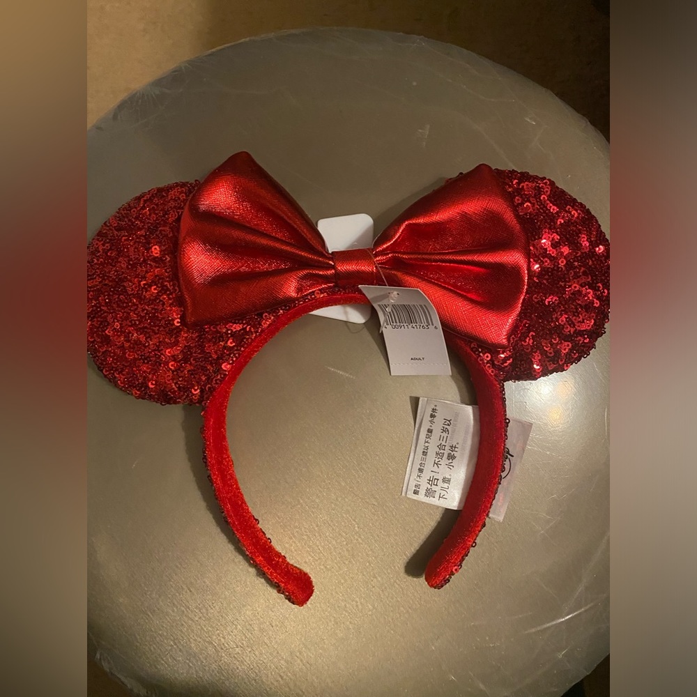 Brand new never worn red sequined Minnie ears .